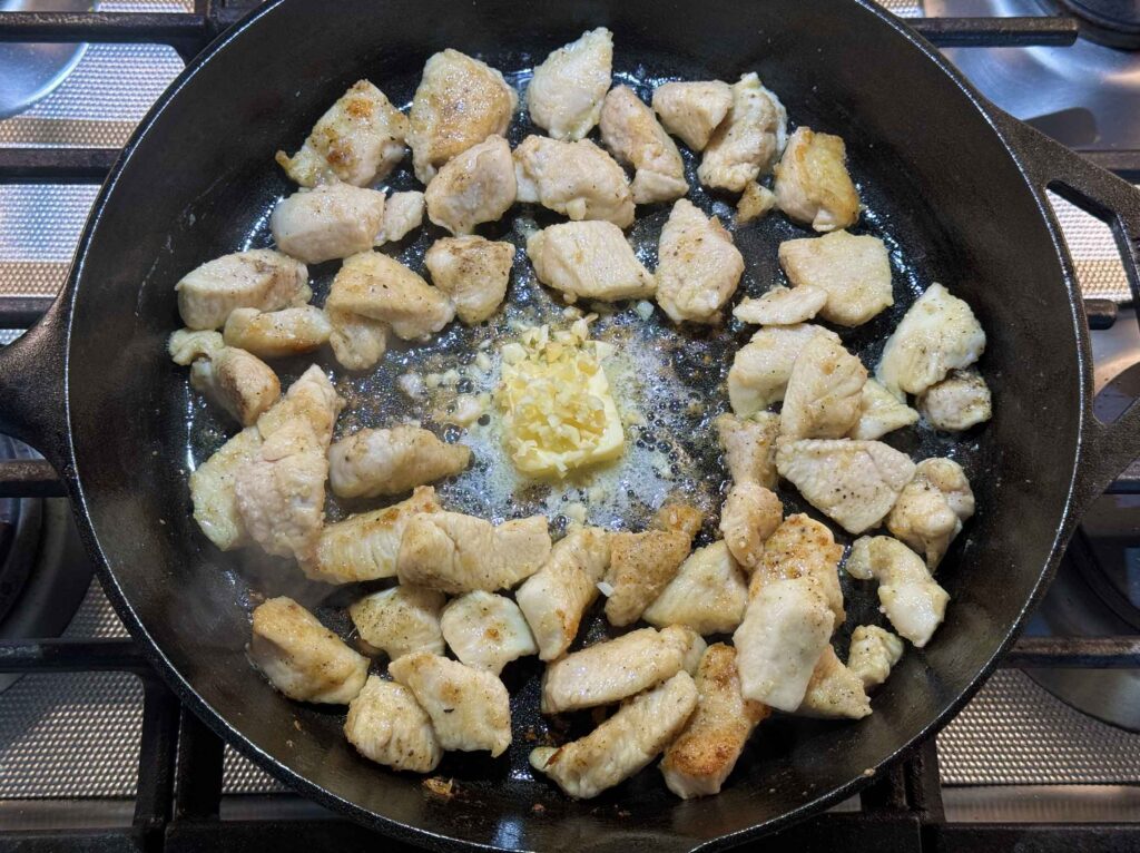 Garlic and butter in skillet with chicken