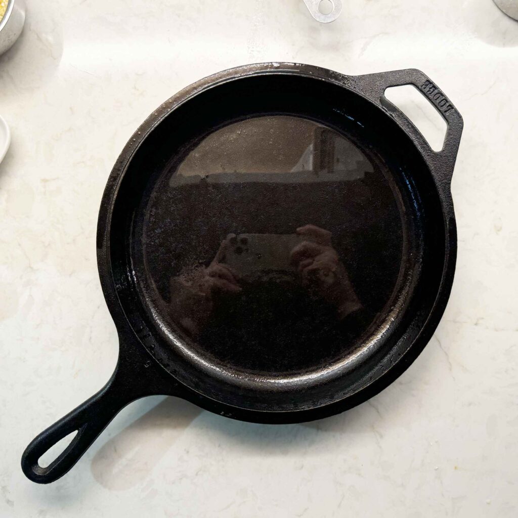 A greased cast iron skillet 10.25" in diameter