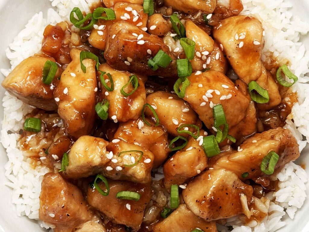 Honey Garlic Chicken over rice in bowl closeup