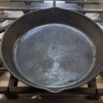 Heating the cast iron skillet for smash burgers