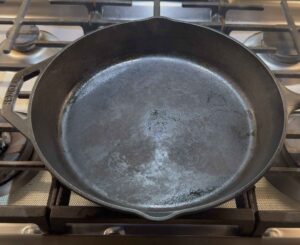 Heating the cast iron skillet for smash burgers