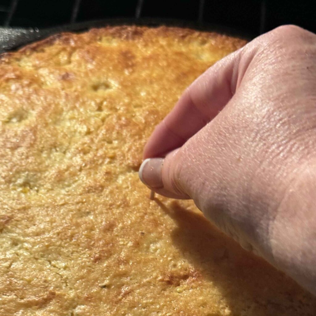 Inserting toothpick into cornbread
