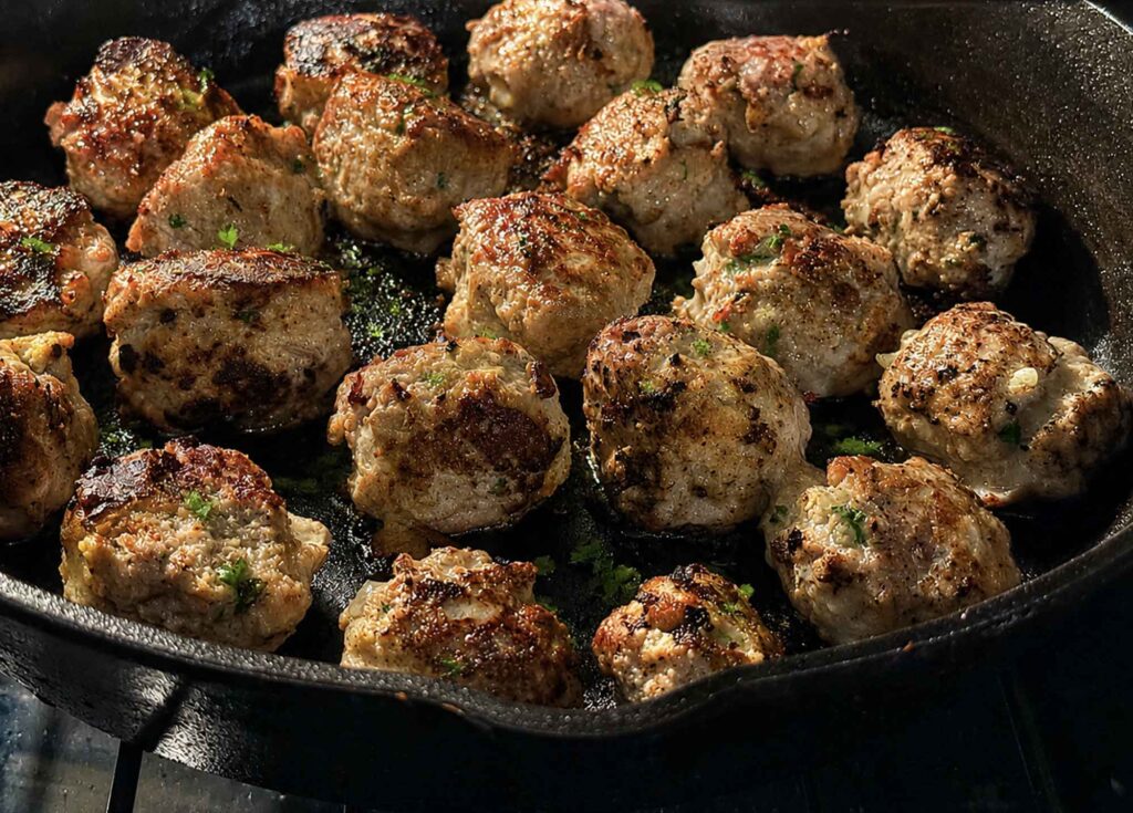 Juicy turkey meatballs in a cast-iron skillet