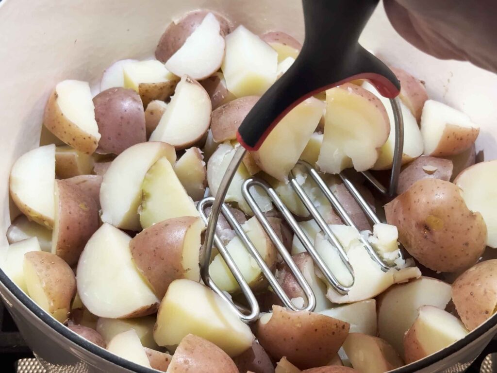 Mashing potatoes in a pot