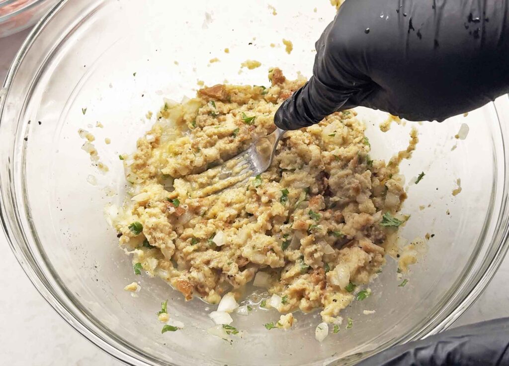 Mashing up the bread, milk, and seasoning mixture for turkey meatballs