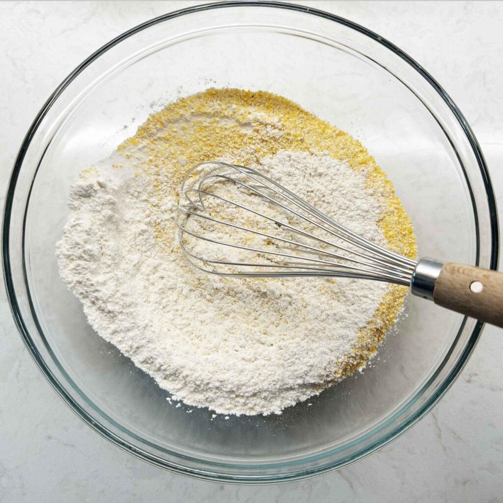 Mixing dry ingredients for cornbread in a bowl