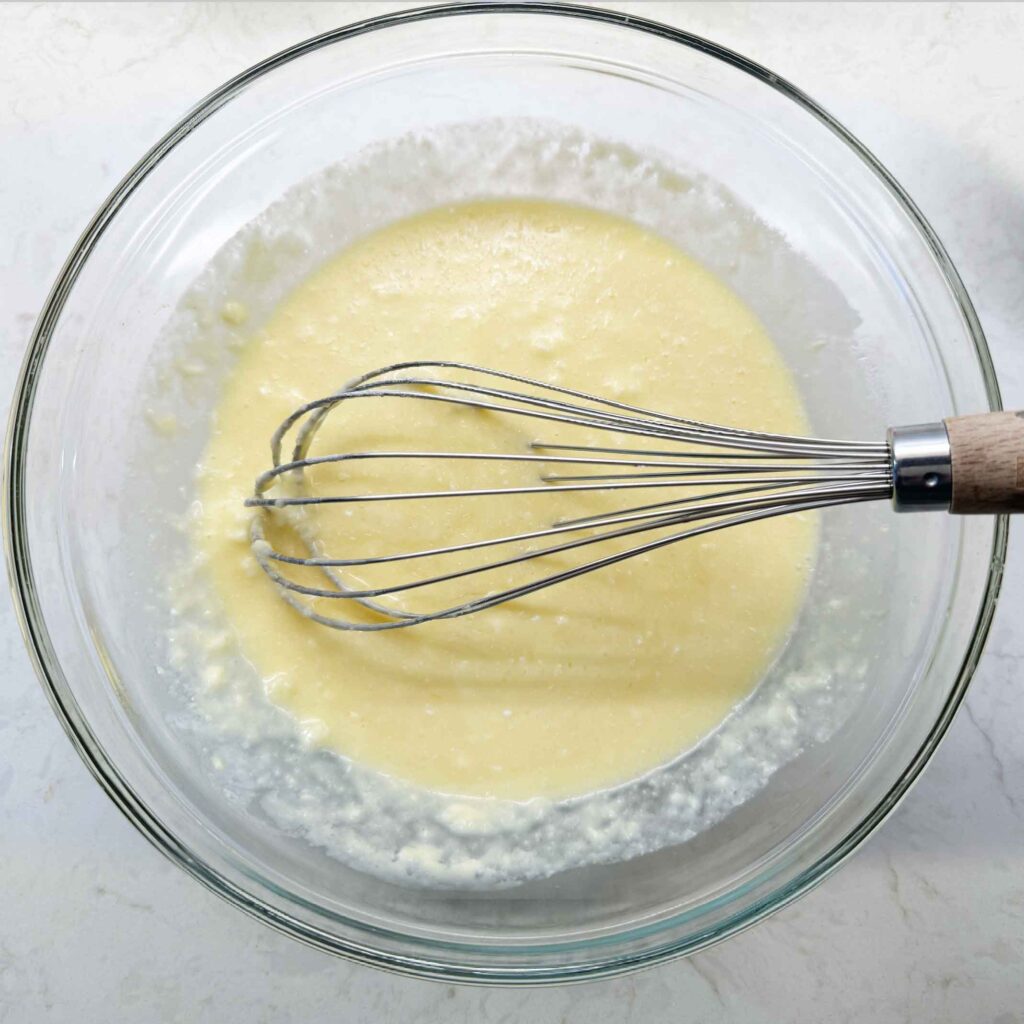 Mixing wet ingredients for cornbread in a bowl