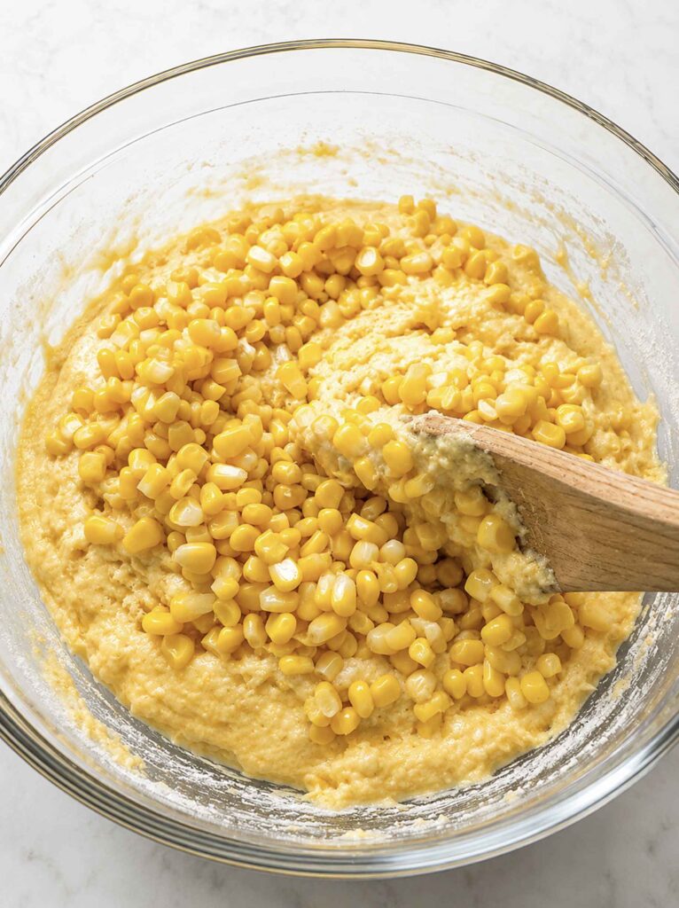 Mixing sweet corn kernels into the cornbread mix