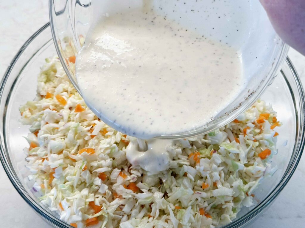 Pouring the dressing on the coleslaw
