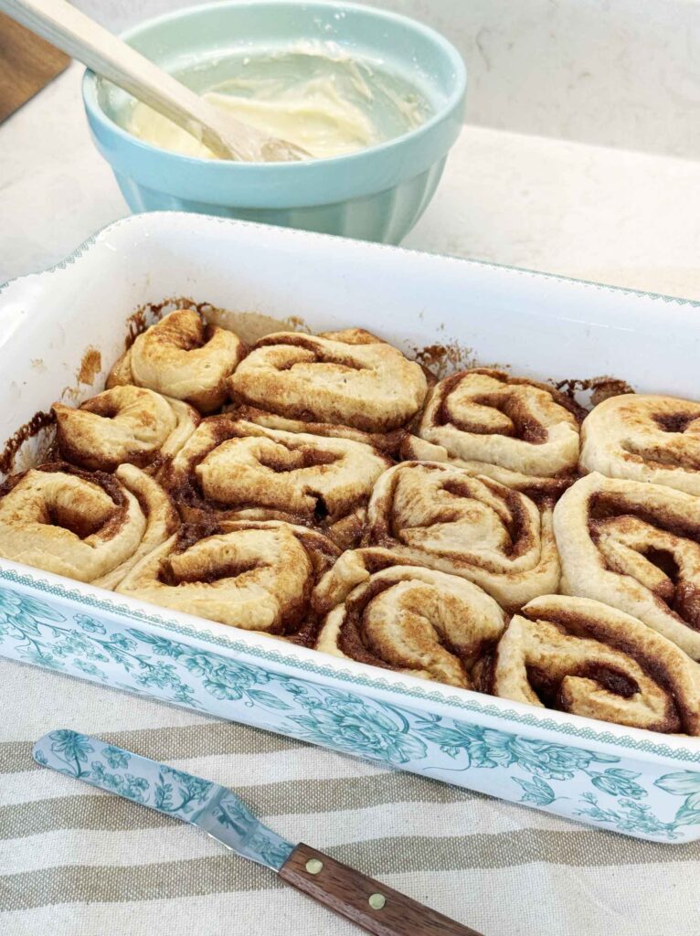 Preparing to frost cinnamon rolls