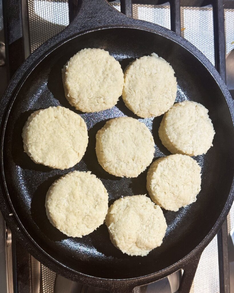 Raw biscuits in a cast iron skillet