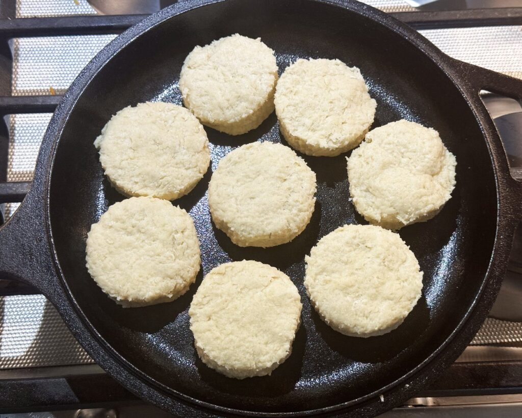 Raw biscuits in a cast iron skillet