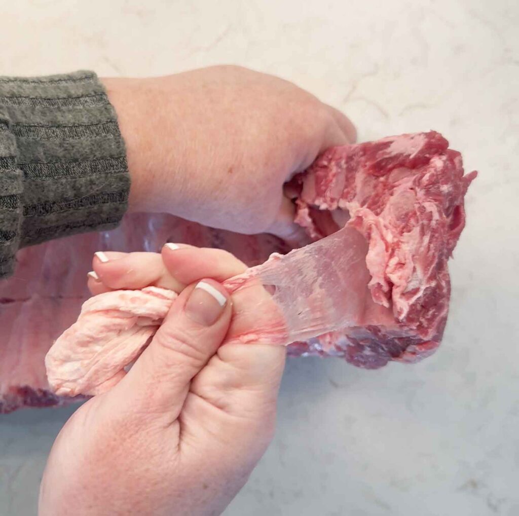 Pulling off the membrane of the ribs with paper towel