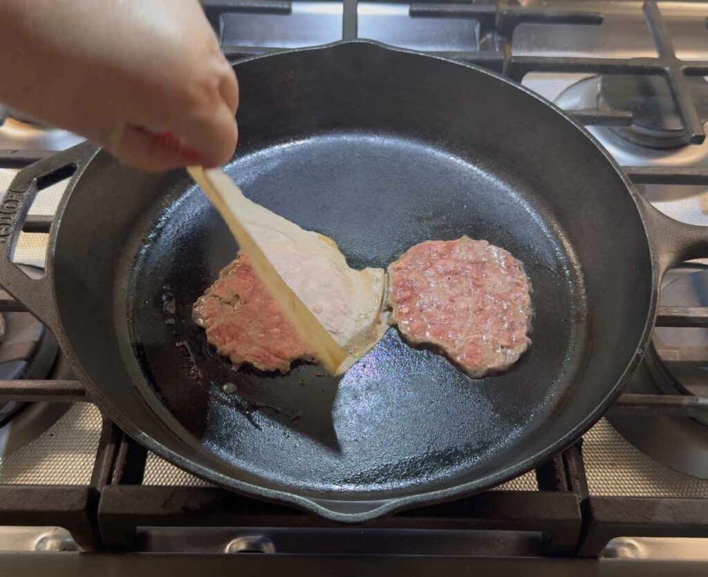Removing a piece of parchment paper from a burger