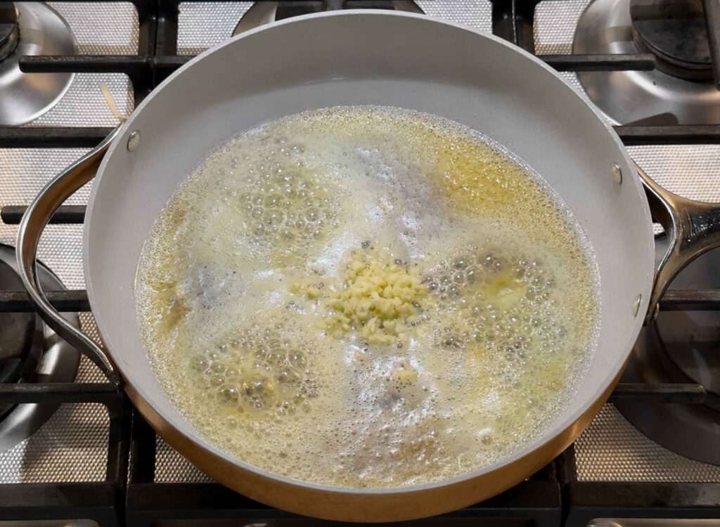 Sauteeing garlic in melted butter in a skillet