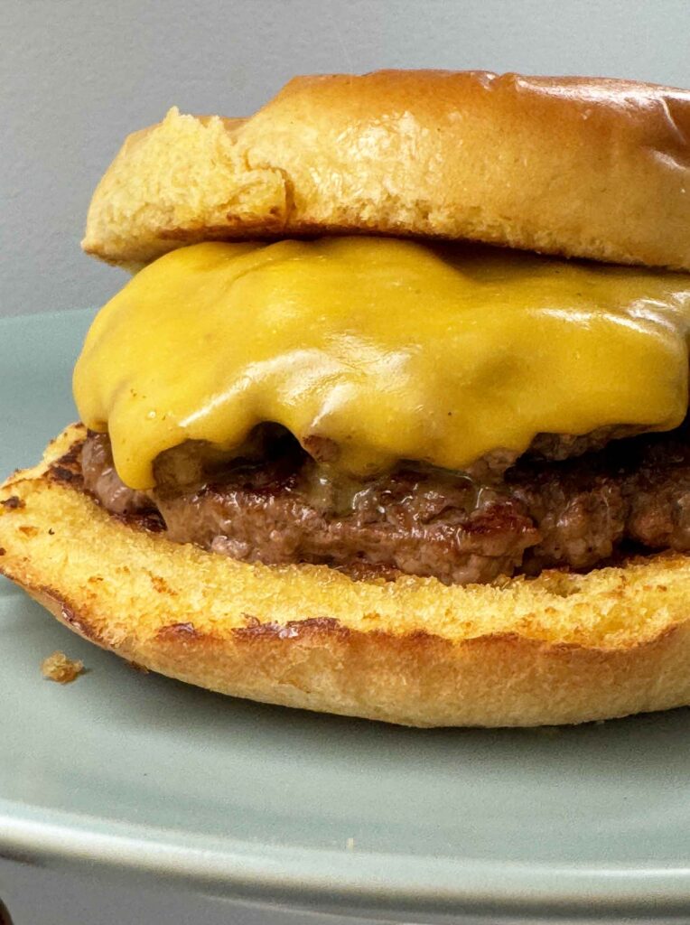 Smash burger with cheese on a blue plate