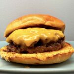 Smash burger with melted cheese on a toasted bun