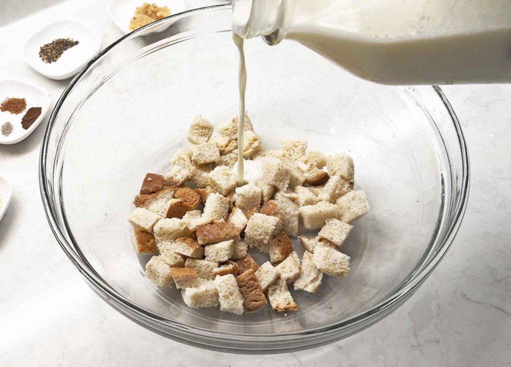 Soaking cubed bread in milk
