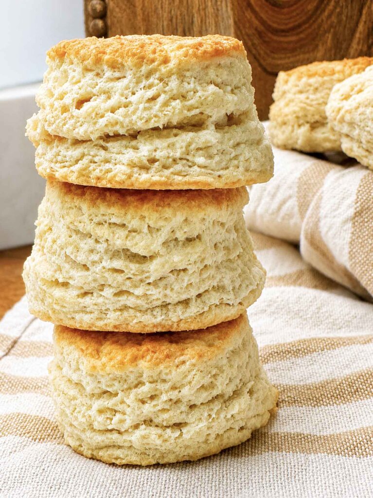 A tall stack of sourdough discard biscuits showing soft, flaky pull-apart layers