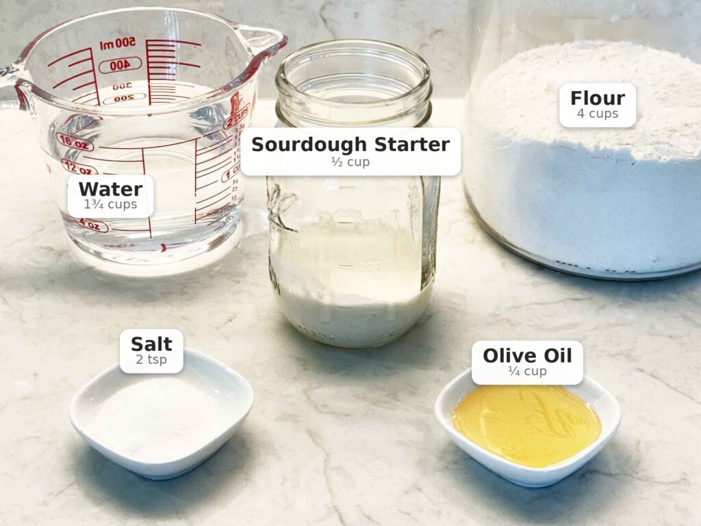 Ingredients to make sourdough focaccia -- water, starter, flour, salt, and olive oil
