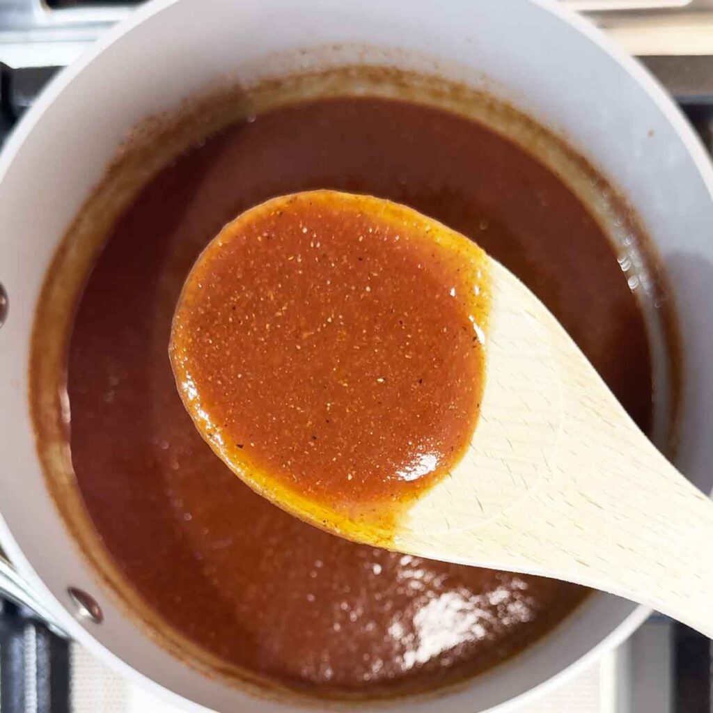 Homemade bbq sauce on a wooden spoon