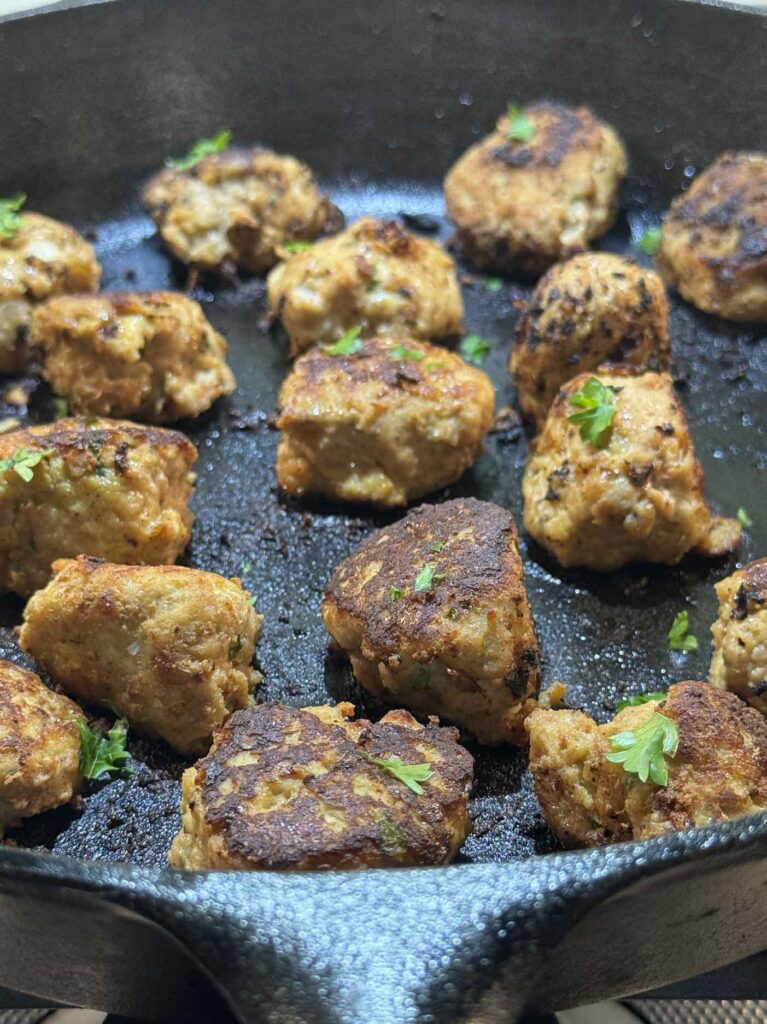 Turkey meatballs with parsley resting after their bake in the oven