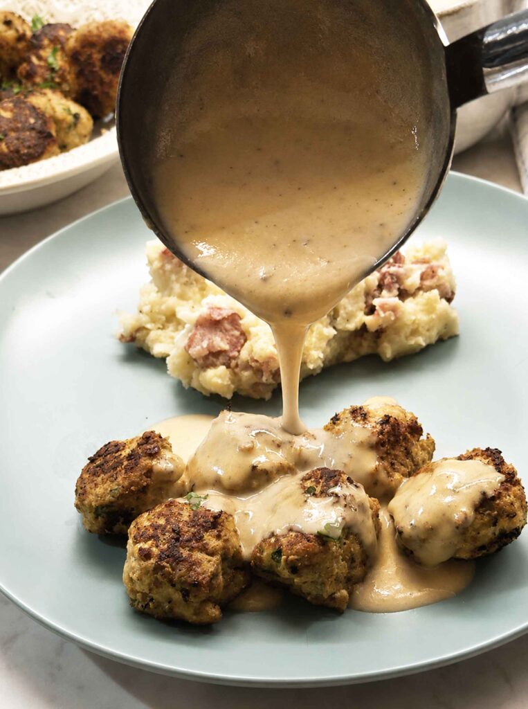 Turkey meatballs with gravy being poured over them