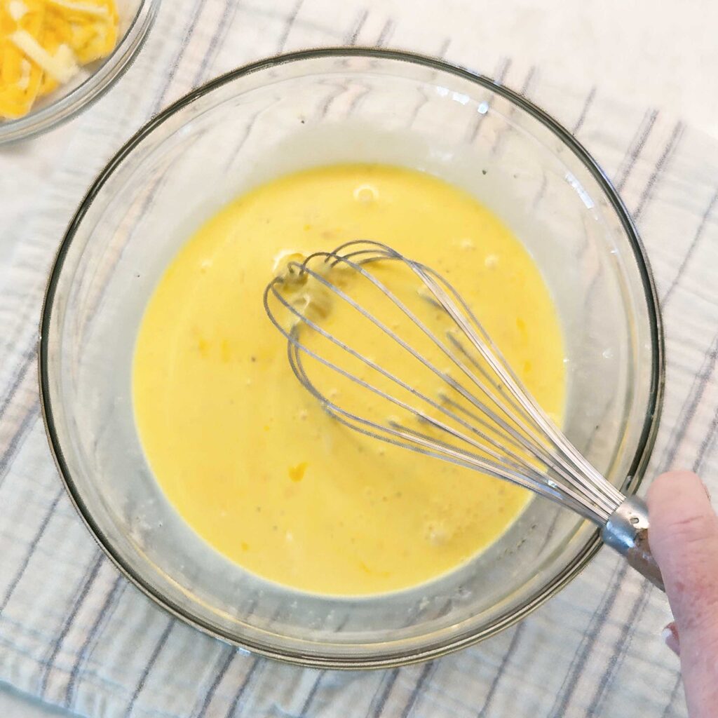 whisking together the egg and dairy for the crustless quiche