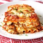 A plated slice of easy lasagna showing the layers of noodles, cheese, and meat sauce.