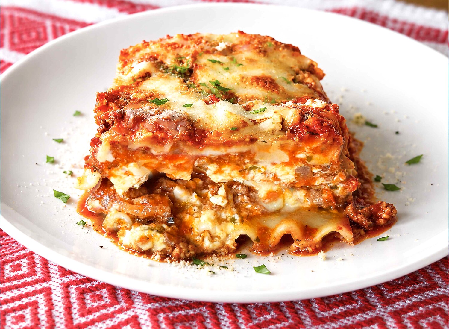 A plated slice of easy lasagna showing the layers of noodles, cheese, and meat sauce.