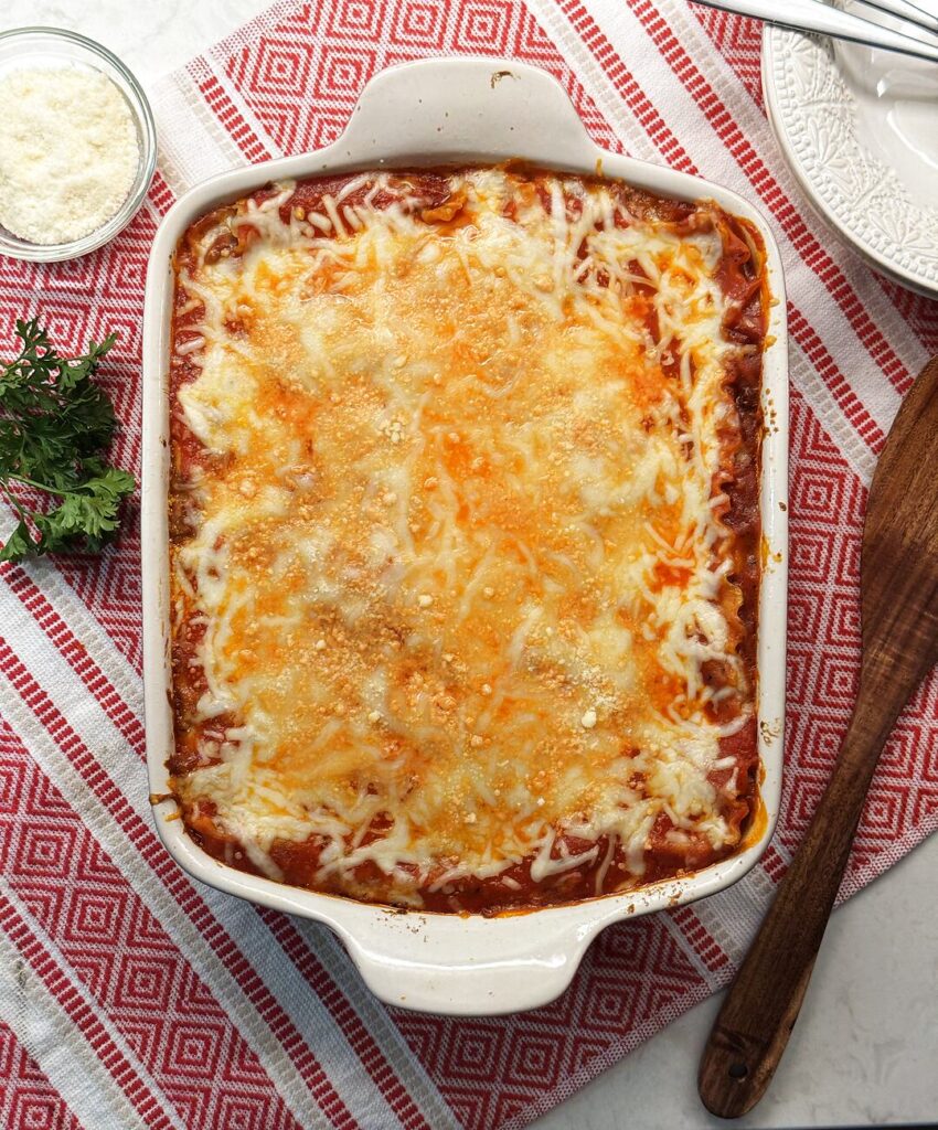 Overhead view of a baked lasagna with bubbly melted cheese.