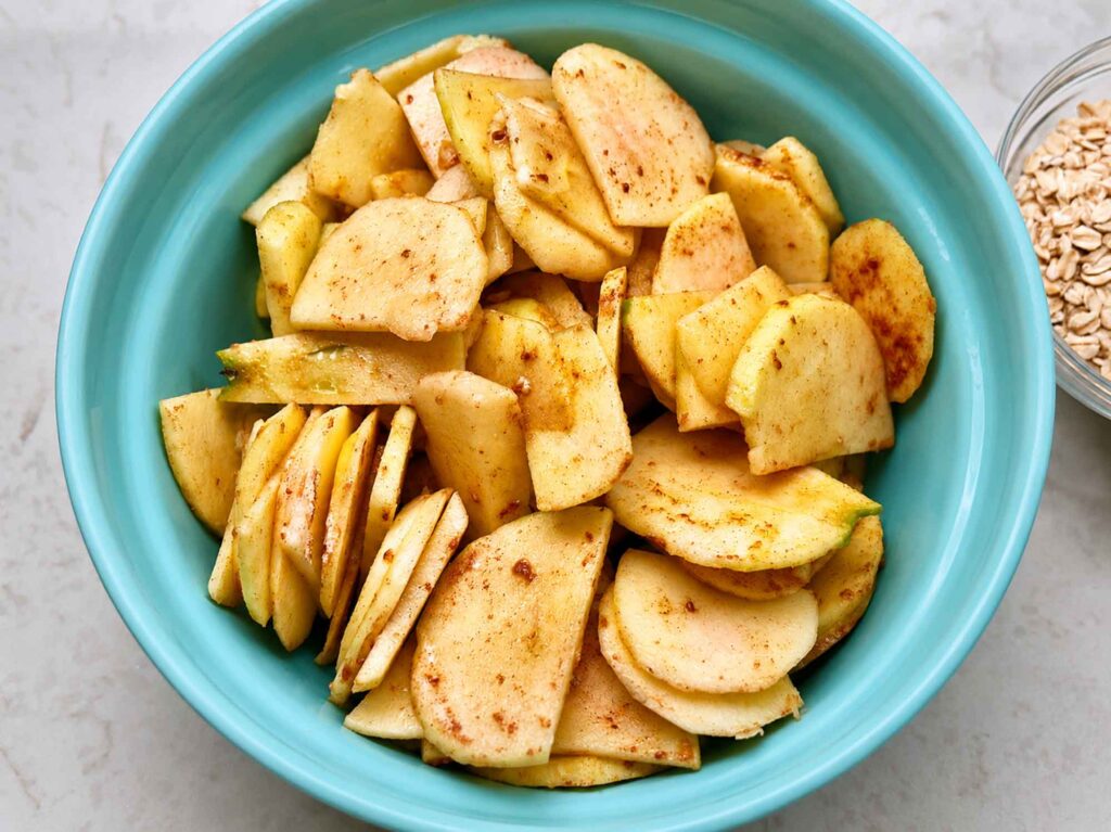 Apple slices tossed with flour, cinnamon, and lemon juice