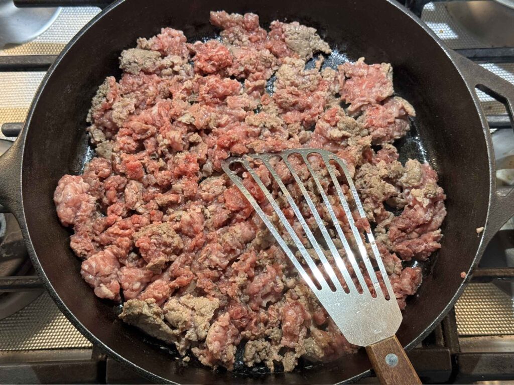 Ground beef and pork browned and crumbled in a skillet