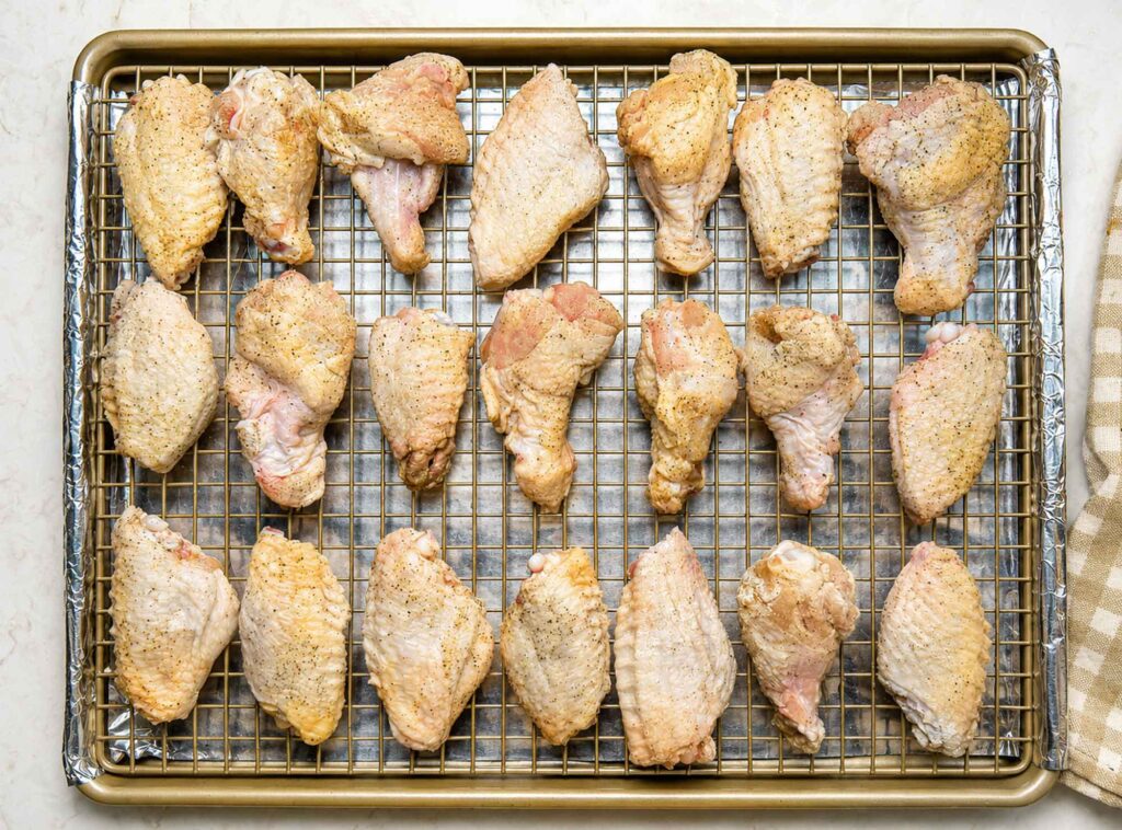 Chicken wings on a rack before baking