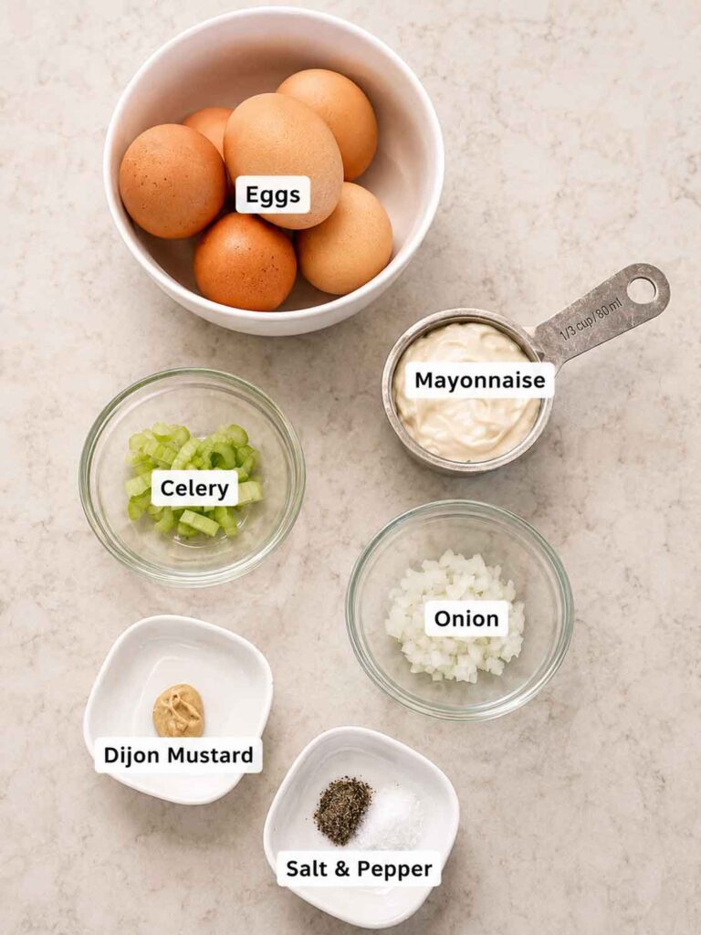 Labeled egg salad ingredients: eggs, mayonnaise, celery, onion, Dijon mustard, salt and pepper