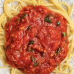 Homestyle Spaghetti Sauce Recipe (Tomato Basil, Better Than the Jar) Homestyle tomato basil spaghetti sauce over pasta in a bowl