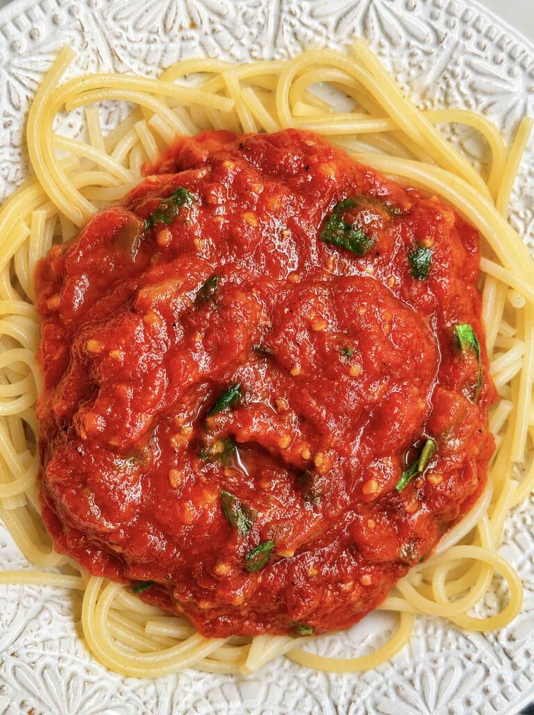 Homestyle tomato basil spaghetti sauce over pasta in a bowl