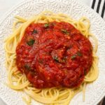 Homestyle tomato basil spaghetti sauce over pasta in a bowl