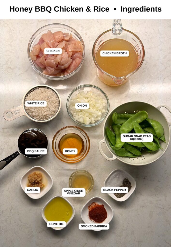 Labeled overhead photo of all the ingredients for honey BBQ chicken and rice, including chicken, broth, white rice, onion, BBQ sauce, honey, garlic, and spices.