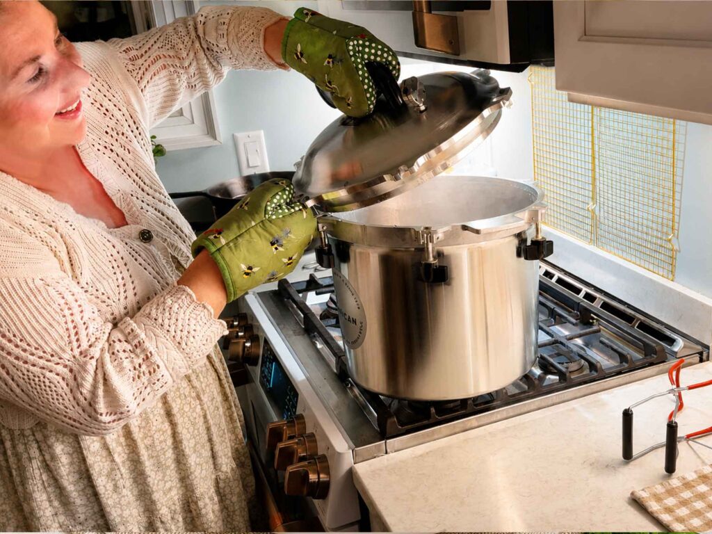 Jennifer Maker opening the pressure canner lid away from her face for safety