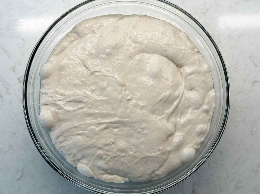 A jiggly, puffy, bubbly sourdough pizza dough after its bulk rise