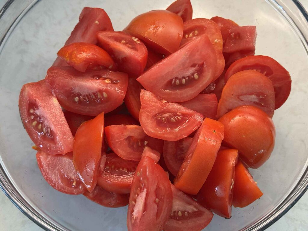Tomatoes in a colander ready to simmer on the stove