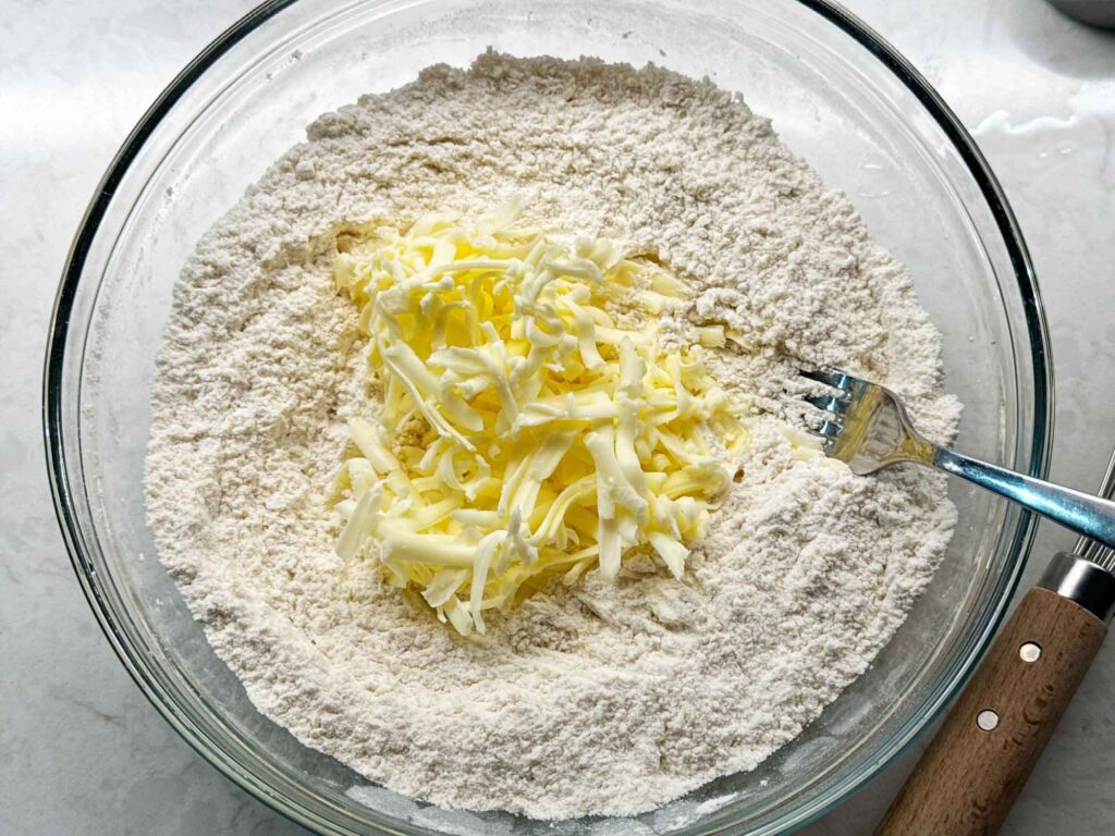 Stirring cold butter into flour mixture for the biscuits