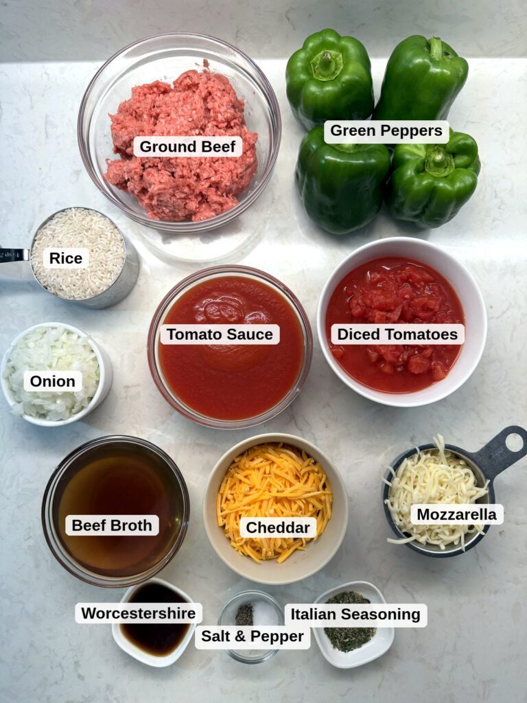 Labeled ingredients for stuffed pepper casserole: ground beef, green peppers, rice, onion, tomato sauce, diced tomatoes, beef broth, cheddar, mozzarella, Worcestershire, salt and pepper, and Italian seasoning.