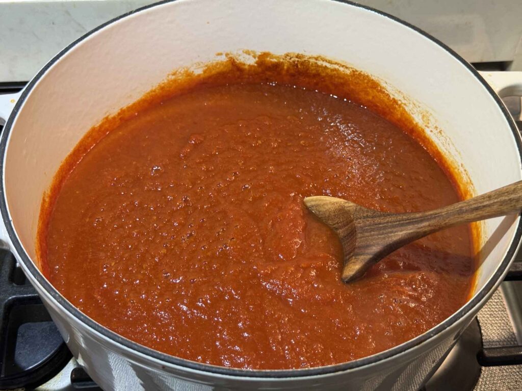 A bright tomato sauce in a large pot on the stove