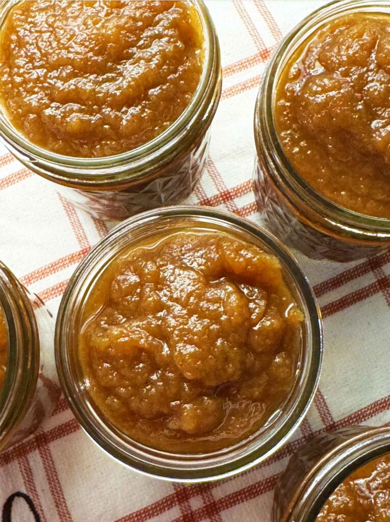 Fresh apple butter in jars, dark and spreadable