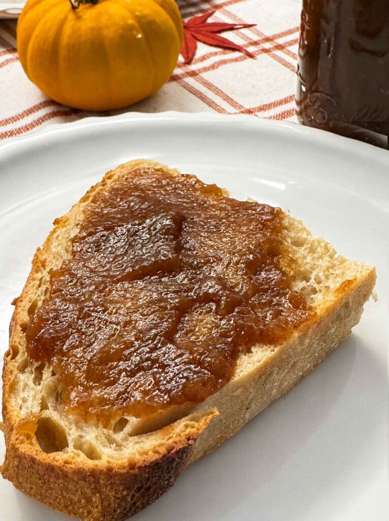 Thick apple butter on a slice of toasted sourdough bread