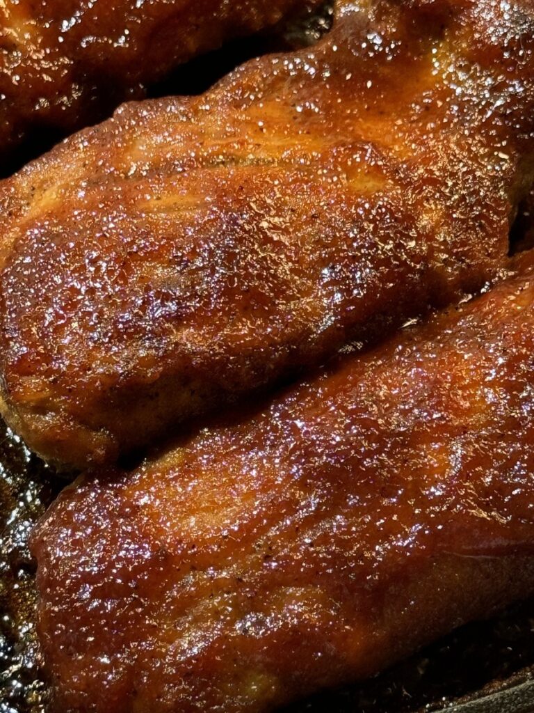 Brown sugar BBQ pork tenderloin with a glossy caramelized barbecue glaze after broiling
