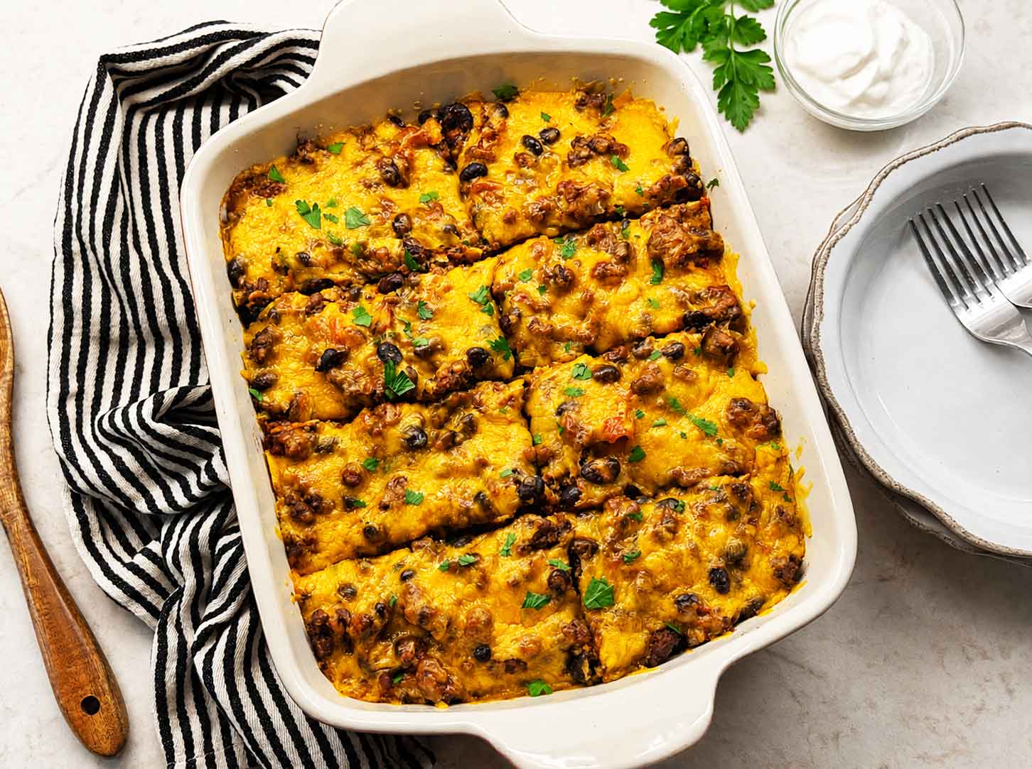 Beef enchilada casserole in a baking dish, sliced and ready to serve