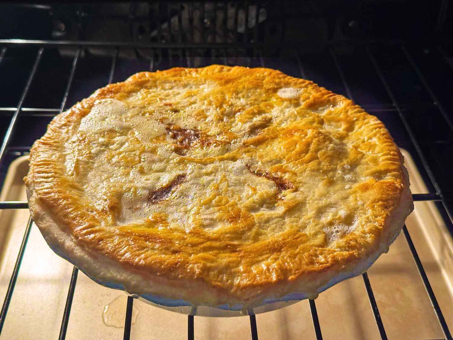 Beef pot pie baking in the oven until the crust is golden